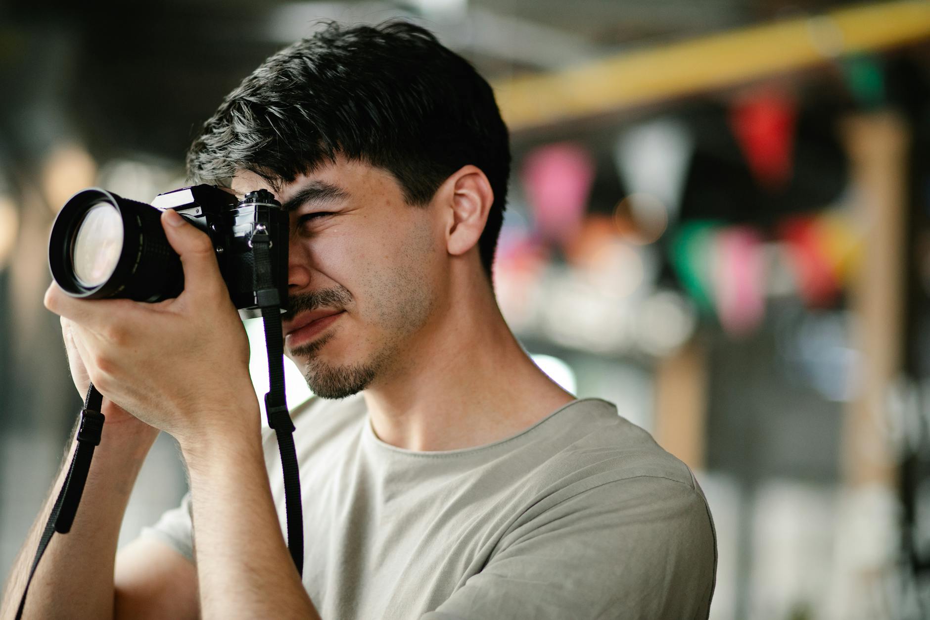 Close-Up Shot of a Man Taking Photos Using a DSLR Camera